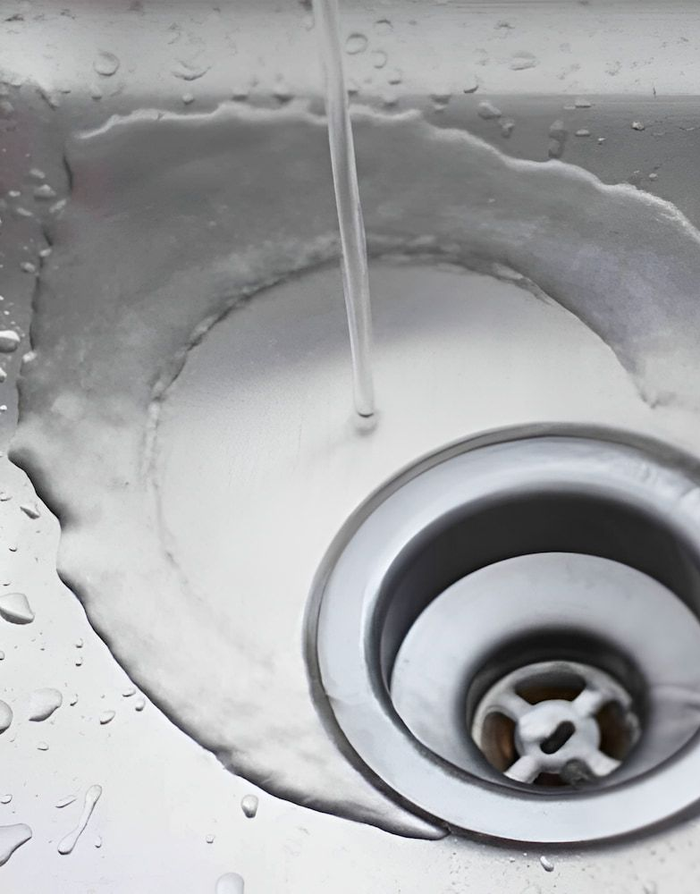 Water Flowing Into a Stainless Steel Sink, Pooling Around the Drain — Corrimal Plumbing Services in Woonona, NSW