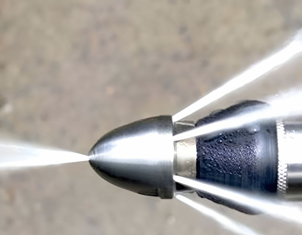 A Jet Nozzle Spraying Water Forcefully — Corrimal Plumbing Services in East Corrimal, NSW